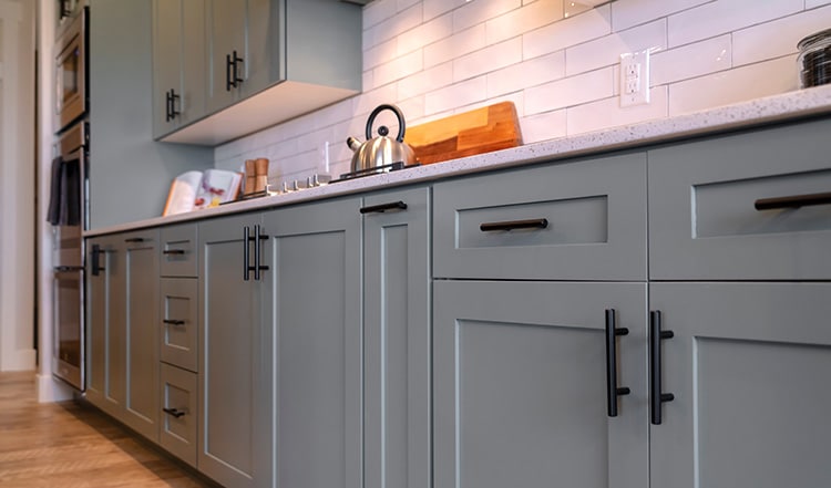 Black pulls on gray cabinets