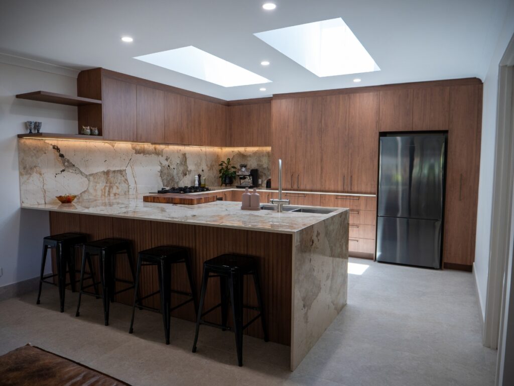 Modern kitchen with marble countertops.