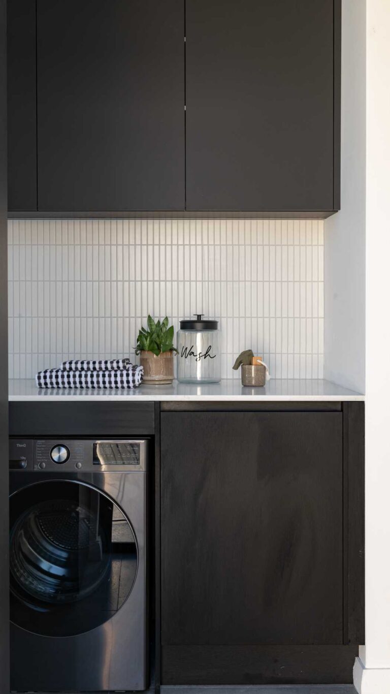 Black laundry with black cabinetry