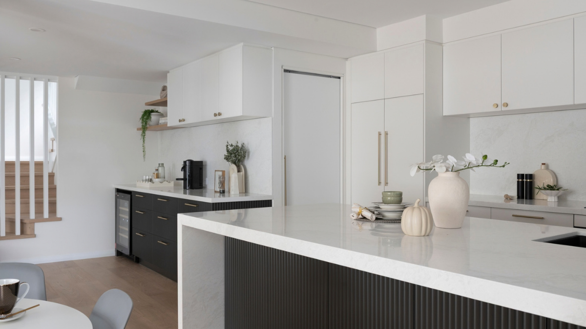 Caesarstone Benchtops 3 Scarborough kitchen with a Caesarstone ICON Glacier Flow waterfall island, fluted black drawers and brushed brass handles