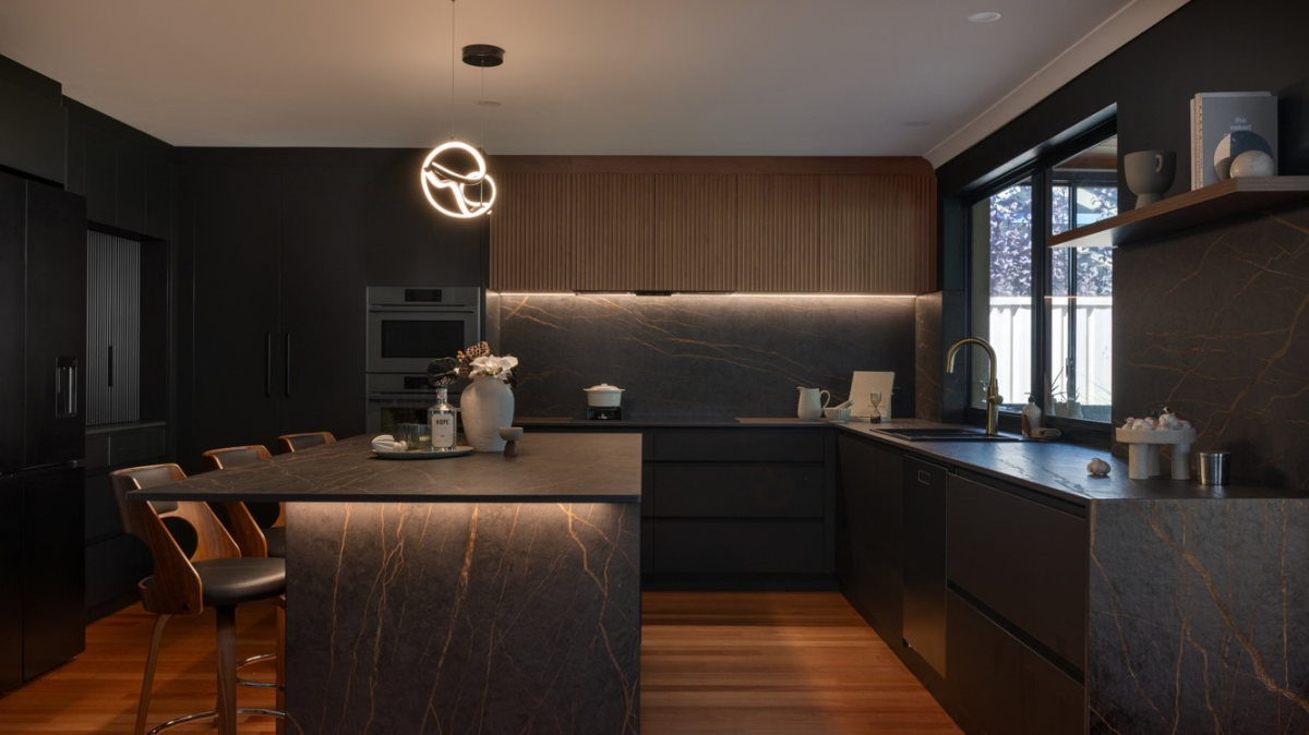 Dekton Benchtops 2 Stirling kitchen with Dekton Laurent benchtops and splashback, matte black cabinetry and fluted timber overhead cabinets