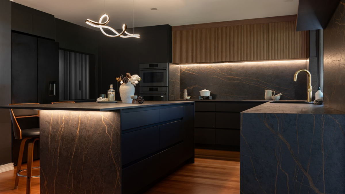 Dekton Benchtops 1 Stirling kitchen with Dekton Laurent benchtops and splashback, matte black cabinetry and fluted timber overhead cabinets