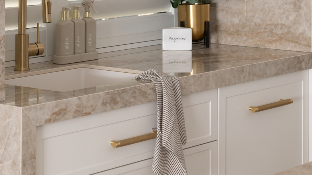 Dekton Benchtops 5 Dekton Taga benchtop and splashback with a brushed brass mixer tap and plantation shutters in an Alkimos kitchen