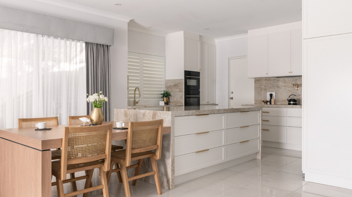 Dekton Benchtops 4 Dekton Taga waterfall island with a timber dining table extension and white shaker drawers in an Alkimos kitchen